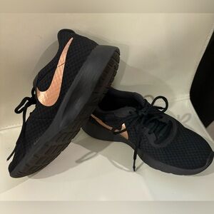Women’s. Black and Gold Nike sneakers